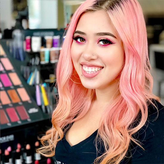 Candy-floss Pink-haired Isabel posing with Colourful Products in the Beauty Store